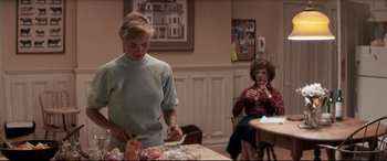 Movie still from “Tootsie” (1982), directed by Sydney Pollack – Two women are sitting at a dining room table preparing food; Medium shot, Over the shoulder angle