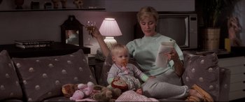 Movie still from “Tootsie” (1982), directed by Sydney Pollack – A woman and a baby are sitting on a bed; Medium shot, High angle