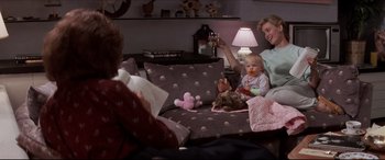 Movie still from “Tootsie” (1982), directed by Sydney Pollack – A woman sitting on a couch with a baby; Medium shot, Over the shoulder angle