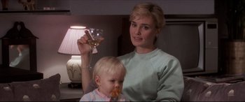 Movie still from “Tootsie” (1982), directed by Sydney Pollack – A woman and a baby are holding a glass of wine; Close Up shot, Over the shoulder angle