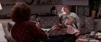 Movie still from “Tootsie” (1982), directed by Sydney Pollack – Two women and a child are sitting on a couch; Medium shot, High angle