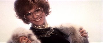 Movie still from “Tootsie” (1982), directed by Sydney Pollack – A person wearing glasses and smiling; Close Up shot, Low angle