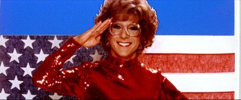Movie still from “Tootsie” (1982), directed by Sydney Pollack – A woman saluting in front of an american flag; Close Up shot, Low angle