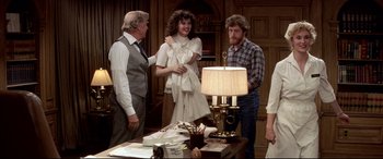 Movie still from “Tootsie” (1982), directed by Sydney Pollack – A group of people standing around a table; Medium shot, Over the shoulder angle
