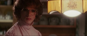 Movie still from “Tootsie” (1982), directed by Sydney Pollack – A woman wearing glasses and a pink shirt; Close Up shot, Over the shoulder angle