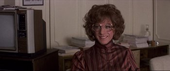 Movie still from “Tootsie” (1982), directed by Sydney Pollack – A woman in a red and white striped shirt and glasses; Close Up shot, Over the shoulder angle