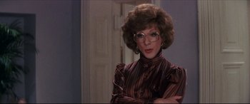 Movie still from “Tootsie” (1982), directed by Sydney Pollack – A woman in a striped shirt with glasses; Close Up shot, Over the shoulder angle