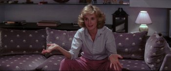 Movie still from “Tootsie” (1982), directed by Sydney Pollack – A woman sitting on top of a couch in a living room; Medium shot, Over the shoulder angle
