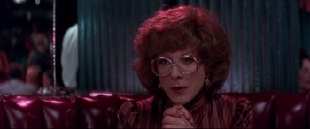 Movie still from “Tootsie” (1982), directed by Sydney Pollack – A woman with glasses sitting on a couch; Close Up shot, Over the shoulder angle
