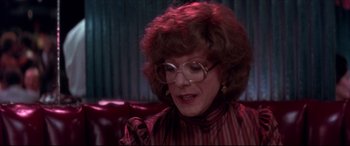Movie still from “Tootsie” (1982), directed by Sydney Pollack – An older woman wearing glasses sitting on a couch; Close Up shot, Over the shoulder angle