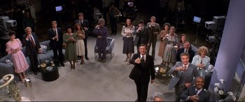 Movie still from “Tootsie” (1982), directed by Sydney Pollack – A group of people standing in a room; Wide shot, High angle