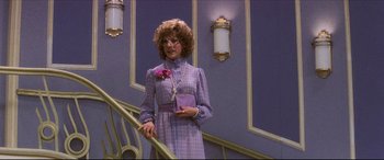Movie still from “Tootsie” (1982), directed by Sydney Pollack – A woman in a purple dress holding a purple purse; Medium shot, Low angle