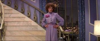 Movie still from “Tootsie” (1982), directed by Sydney Pollack – A woman in a purple dress standing on stairs; Medium shot, Low angle