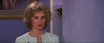 Movie still from “Tootsie” (1982), directed by Sydney Pollack – A person wearing a necklace near a wall; Close Up shot, Over the shoulder angle