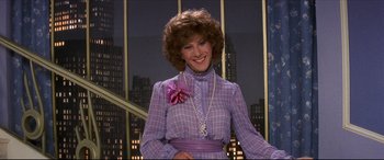 Movie still from “Tootsie” (1982), directed by Sydney Pollack – A woman in a purple dress with a purple flower in her hair; Medium shot, Over the shoulder angle