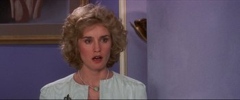 Movie still from “Tootsie” (1982), directed by Sydney Pollack – A person wearing a necklace near a wall; Close Up shot, Over the shoulder angle