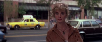 Movie still from “Tootsie” (1982), directed by Sydney Pollack – A woman standing on the side of the road in front of a yellow taxi cab; Close Up shot, Over the shoulder angle