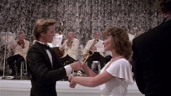 Movie still from “Top Secret!” (1984), directed by Jim Abrahams – A man and a woman are dancing in front of an orchestra; Medium shot, Low angle