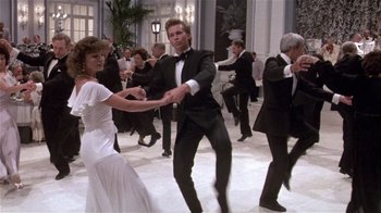 Movie still from “Top Secret!” (1984), directed by Jim Abrahams – A group of people in formal wear dancing in a ballroom; Wide shot, Low angle