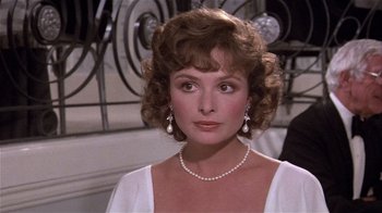Movie still from “Top Secret!” (1984), directed by Jim Abrahams – A person wearing a necklace; Close Up shot, Over the shoulder angle