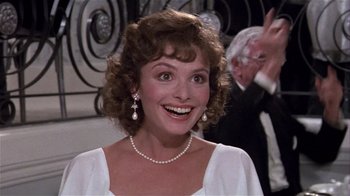Movie still from “Top Secret!” (1984), directed by Jim Abrahams – A person wearing a dress; Close Up shot, Over the shoulder angle