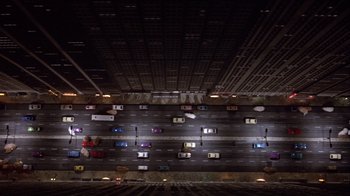 Movie still from “Top Secret!” (1984), directed by Jim Abrahams – An overhead view of a street with many cars on it; Extreme Wide shot, Overhead angle