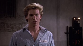 Movie still from “Top Secret!” (1984), directed by Jim Abrahams – A person wearing a blue shirt; Close Up shot, High angle