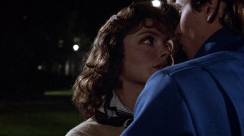 Movie still from “Top Secret!” (1984), directed by Jim Abrahams – A woman's face as a man looks on; Close Up shot, Over the shoulder angle