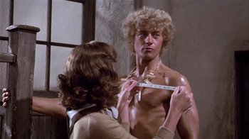 Movie still from “Top Secret!” (1984), directed by Jim Abrahams – A woman is looking at a man in the mirror; Medium shot, Low angle