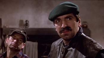 Movie still from “Top Secret!” (1984), directed by Jim Abrahams – A person wearing a hat; Close Up shot, Low angle