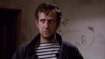 Movie still from “Top Secret!” (1984), directed by Jim Abrahams – A person wearing a shirt and jacket; Close Up shot, Low angle