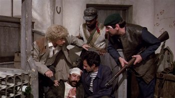 Movie still from “Top Secret!” (1984), directed by Jim Abrahams – A group of men standing next to each other in a room; Medium shot, High angle