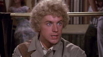 Movie still from “Top Secret!” (1984), directed by Jim Abrahams – A person wearing a jacket; Close Up shot, Over the shoulder angle