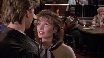 Movie still from “Top Secret!” (1984), directed by Jim Abrahams – A man and a woman are talking to each other; Close Up shot, Over the shoulder angle