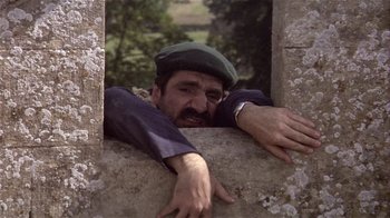 Movie still from “Top Secret!” (1984), directed by Jim Abrahams – A man leaning on a wall with his hands on the wall; Close Up shot, Low angle