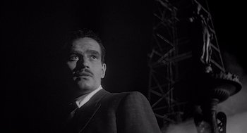 Movie still from “Touch of Evil” (1958), directed by Orson Welles – A black and white photo of a man in a suit; Close Up shot, Low angle