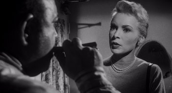 Movie still from “Touch of Evil” (1958), directed by Orson Welles – An old photo of a woman looking in the mirror; Close Up shot, Low angle