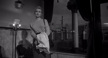 Movie still from “Touch of Evil” (1958), directed by Orson Welles – A black and white photo of a woman holding a towel; Medium shot, Low angle
