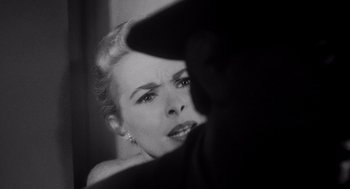 Movie still from “Touch of Evil” (1958), directed by Orson Welles – A black - and - white photo of a woman looking at the camera; Close Up shot, Over the shoulder angle