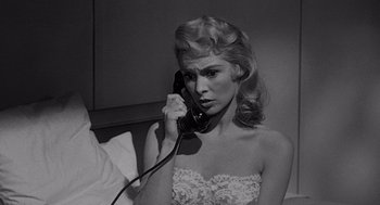 Movie still from “Touch of Evil” (1958), directed by Orson Welles – A black and white photo of a woman talking on a phone; Close Up shot, Over the shoulder angle
