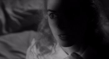 Movie still from “Touch of Evil” (1958), directed by Orson Welles – A black - and - white photo of a woman's face; Close Up shot, Low angle
