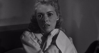 Movie still from “Touch of Evil” (1958), directed by Orson Welles – A black - and - white photo of a woman in a dress; Close Up shot, Low angle