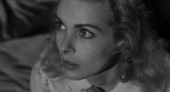 Movie still from “Touch of Evil” (1958), directed by Orson Welles – A black - and - white photo of a woman's face; Close Up shot, High angle