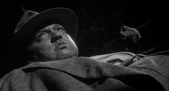 Movie still from “Touch of Evil” (1958), directed by Orson Welles – A man in a hat and a blanket; Close Up shot, Low angle