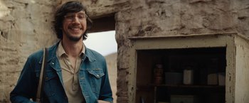 Movie still from “Tracks” (2013), directed by John Curran – A man standing in front of an old building; Medium shot, Over the shoulder angle