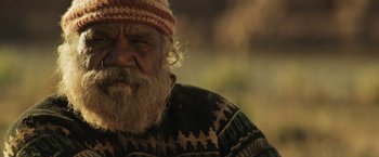 Movie still from “Tracks” (2013), directed by John Curran – An old man with a beard wearing a hat; Close Up shot, Over the shoulder angle