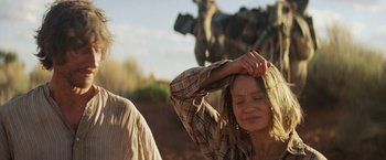 Movie still from “Tracks” (2013), directed by John Curran – A woman with her hands on her head in front of another woman; Close Up shot, Low angle