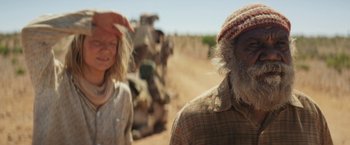 Movie still from “Tracks” (2013), directed by John Curran – A man and a woman standing on a dirt road; Close Up shot, Over the shoulder angle