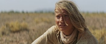 Movie still from “Tracks” (2013), directed by John Curran – A woman with long blonde hair in a grassy field; Close Up shot, Low angle