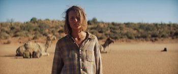 Movie still from “Tracks” (2013), directed by John Curran – A woman standing in the middle of the desert; Medium shot, Low angle